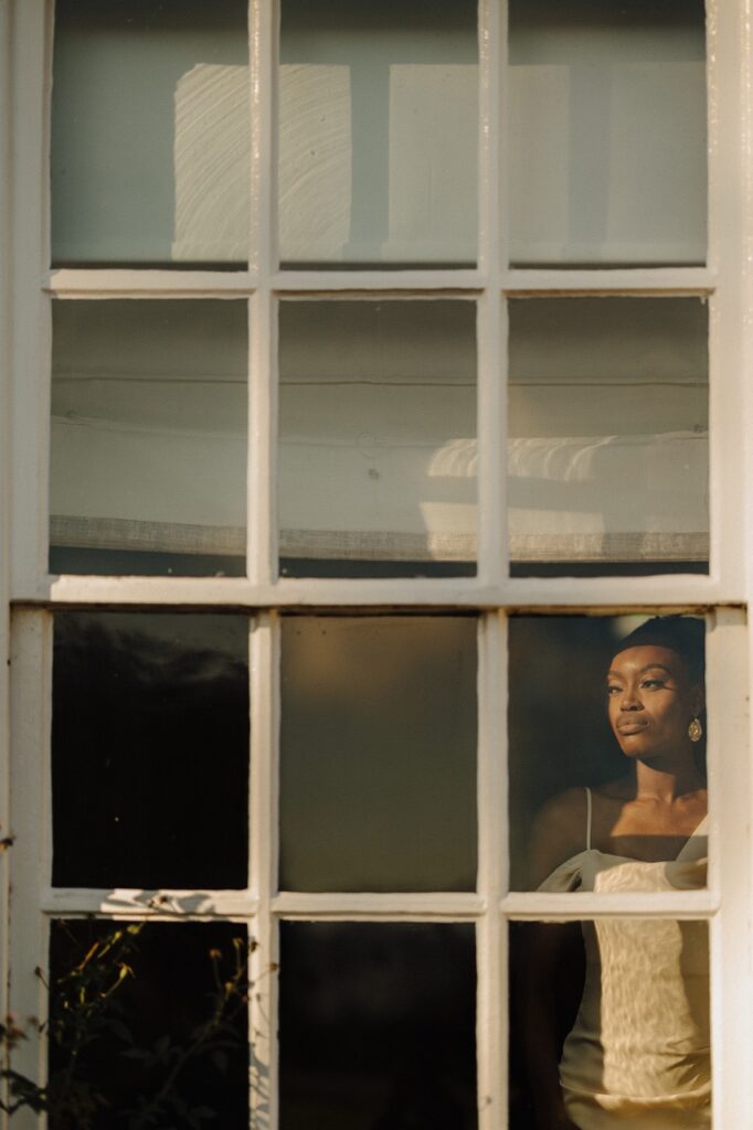 Woman Looking Out Of The Window