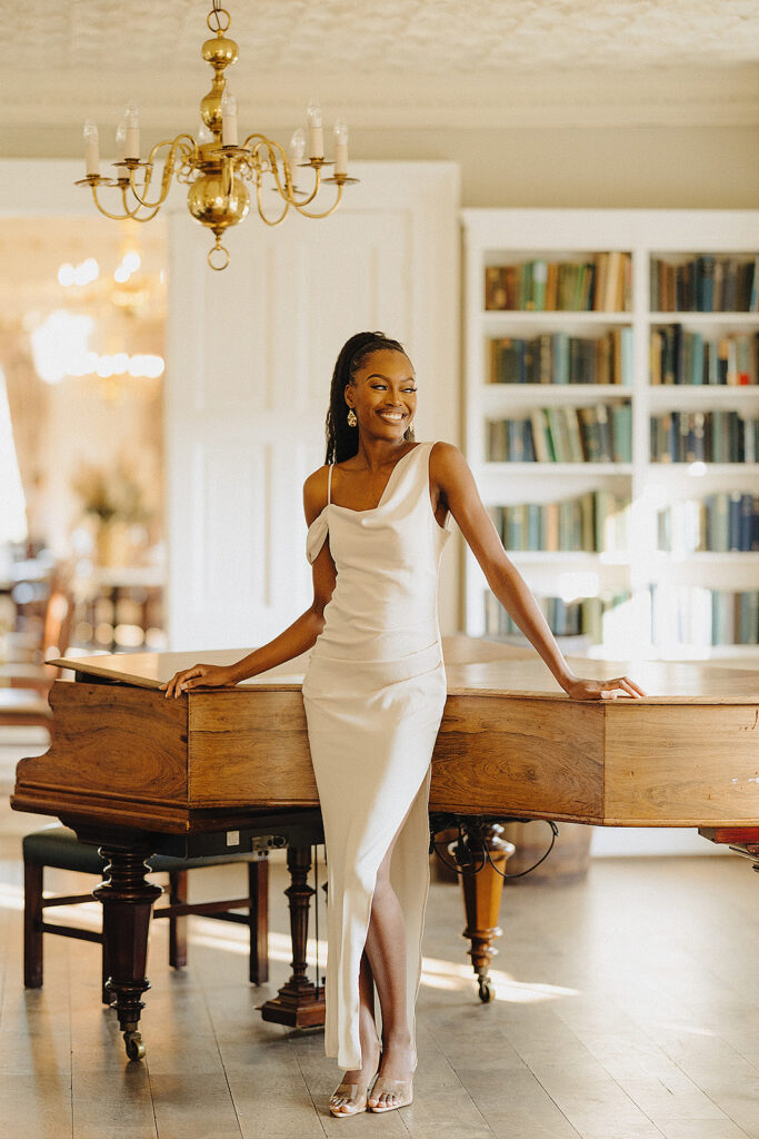 Girl smiling in front of a piano